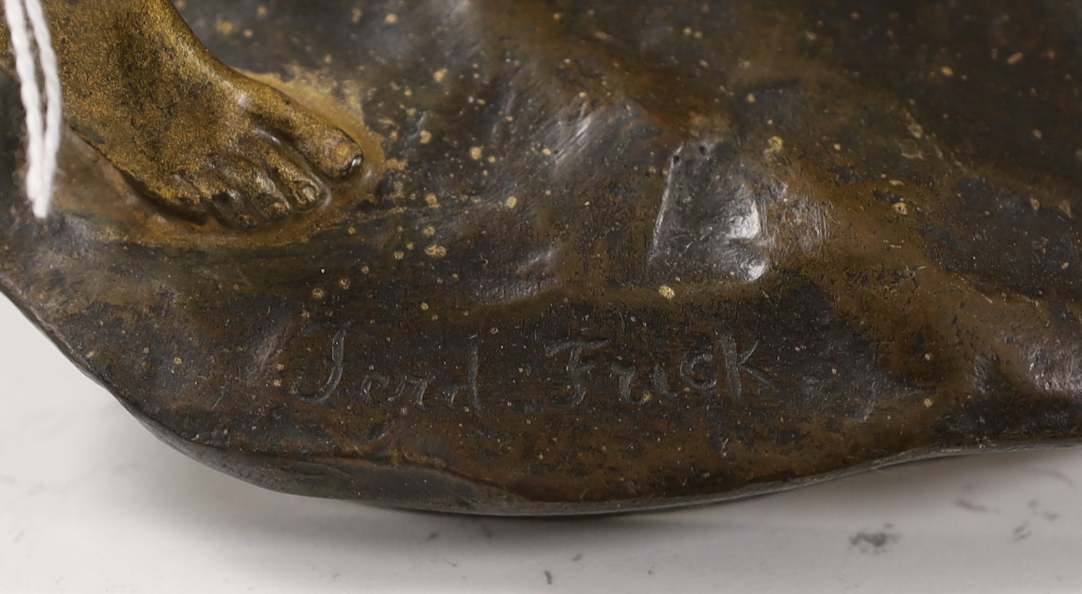 A Ferdinand Frick (1878-1939) for Goldscheider, bronze study of a girl with a cat, signed, 24cm high